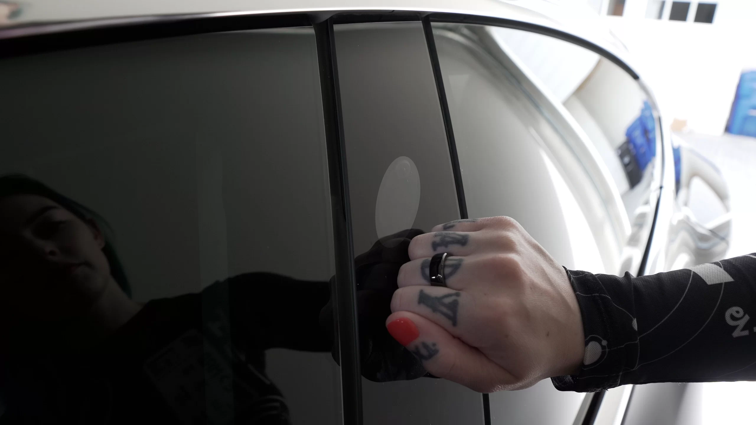 Woman knocking on the side of a tesla while wearing the Apex Ring